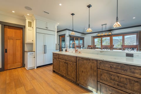 Gourmet kitchen dishwasher, gas range, and drip-style coffee maker.