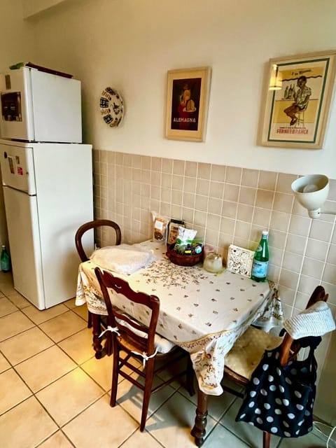 detail of table in kitchen and refridgerator, freezer above