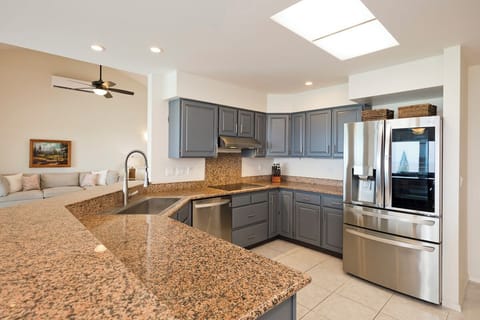 Kitchen area is offering serene view of the pool & ocean