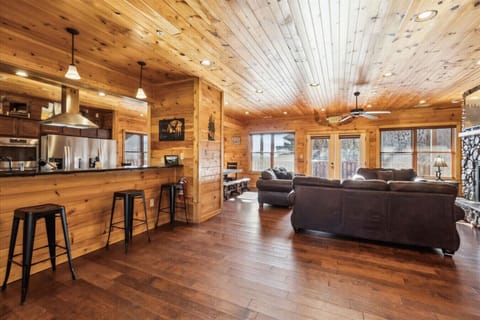 Step inside this 9-bedroom cabin boasting 4548 sq. ft of space and admire the rustic, wood inspired details of its charming interior.