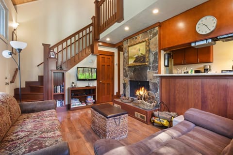 Cozy and spacious living area with TV and fireplace