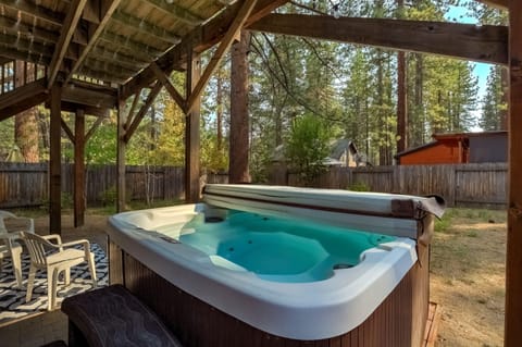 Gas BBQ, hot tub and seating in the backyard