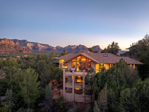 Experience luxury at this 7,000 sq ft Uptown Sedona estate, perfect for large groups or families. With 5 bedrooms, 10 beds, and 4.5 baths, it comfortably hosts up to 14 guests and features sweeping red rock views throughout.