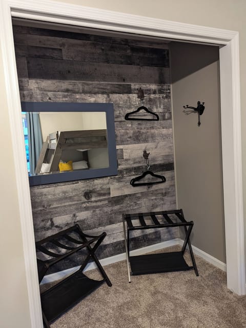 Bunk room closet with hangers and luggage racks