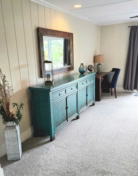 - Elegant dresser with mirror adds charm to master bedroom - Workspace desk provides a spot for writing or remote work - Decor accents and soft carpet create a relaxing retreat