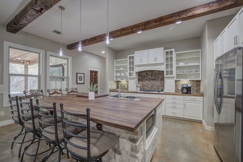 Perfect for meal prep or casual dining, the oversized island offers ample space with stylish finishes.