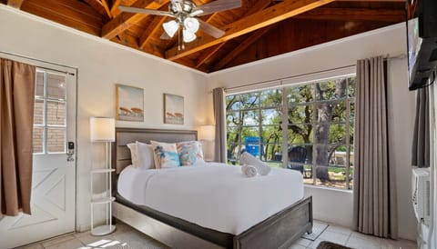 Ceiling fans, cabin vibes, and a queen that rules dreams. Sleep like royalty, beam to beam!