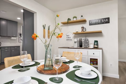 Embrace the perfect start to your day with our charming dining and coffee corner. The dining table, set with elegant dishware and vibrant floral accents, offers a warm space for meals.