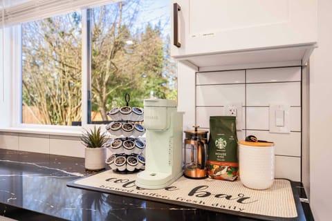 Your mornings are sorted with our charming coffee bar! A Keurig machine, French press, and an assortment of pods are ready to help you start your day. The picturesque window view adds a touch of nature to your coffee routine.