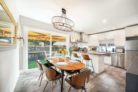 Our dining area is filled with natural light, thanks to the sliding glass doors that open to a lovely outdoor space. The elegant wooden dining table comfortably seats six, making it ideal for family meals or friendly dinners.