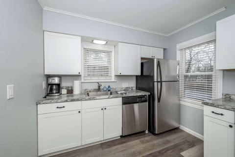 The sleek kitchen offers ample space & all the comforts of home