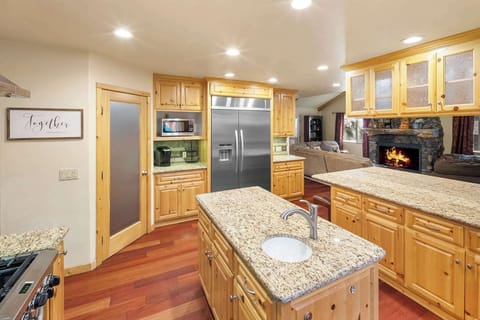 Beautiful modern open eat in kitchen. With huge refrigerator and stainless steel appliances. Ready for your mountain feast.