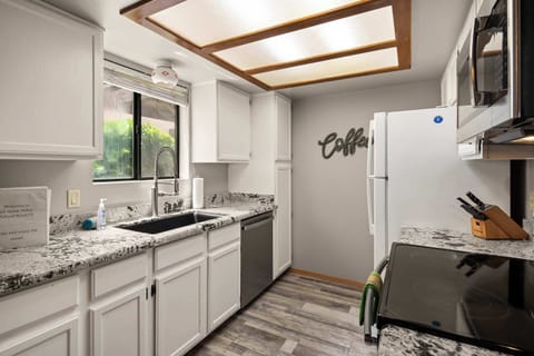 Fully equipped kitchen with stainless steel appliances, ample counter space, and all you need to cook a delicious meal.