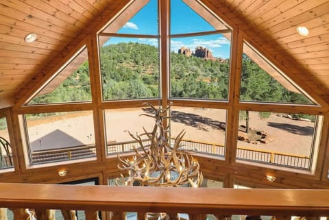 Enjoy the view from the upstairs indoor balcony, framed by unique window design.