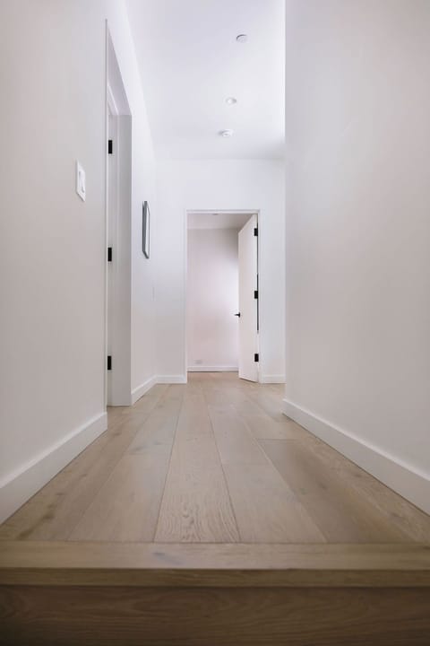corridor to upstairs bedrooms with 2 primary bedrooms