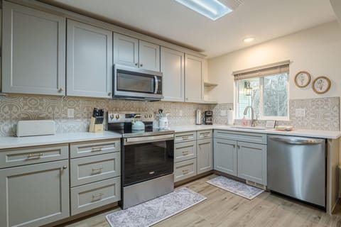 Stainless steel appliances seamlessly blend modern convenience into this dreamy kitchen.