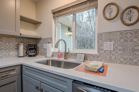Rustic wood accents, and vintage-inspired fixtures create the perfect farmhouse ambiance in the well-stocked kitchen.