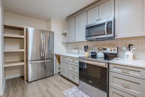 Ample pantry space keeps essentials organized and within easy reach, creating a seamless and inviting cooking experience in this charming culinary haven.