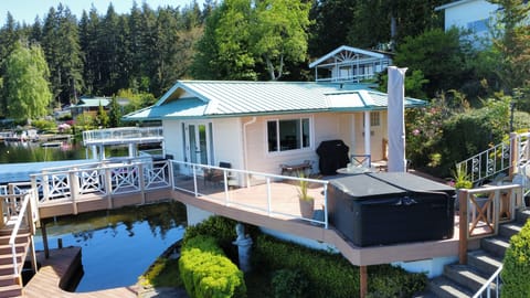 The large composite deck includes a hot tub, fire pit, & 11Ft. rotating umbrella