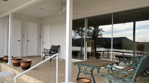 Covered porch has seating and view. Access to 2nd bathroom, garage and storage.