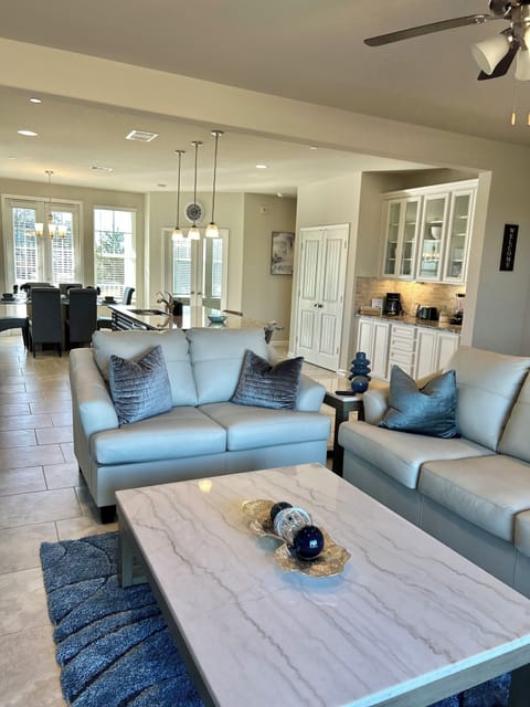 Large living room with leather sofas and 65in smart tv .