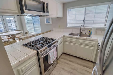 Tile counter, plenty of space to entertain at the kitchen bar
