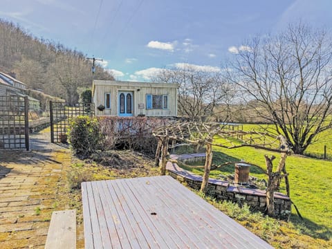 Outdoor table and benches, including arch seating area with fireplace | Rosie - Tanyrallt Holidays Lets, Llanybydder, near Lampeter