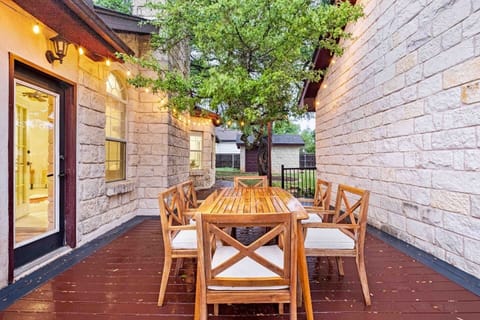 Wine, dine, and unwind: Our enchanting outdoor dining space with stunning string lights is the ideal setting for a relaxing evening in Dripping Springs.