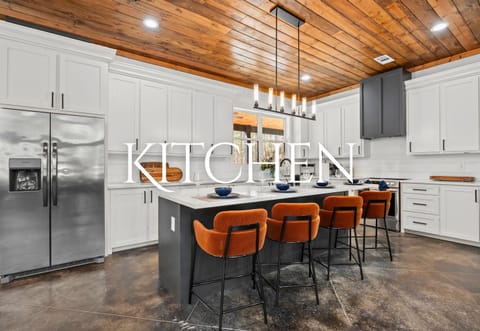This beautifully designed kitchen offers top-of-the-line appliances, plenty of counter space, and an oversized island perfect for meal prep or casual dining.