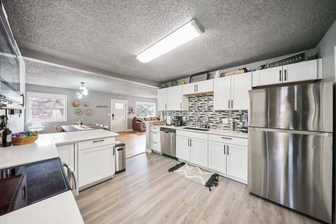 The kitchen is fully stocked with a blender, coffee maker, french press maker, coffee grinder, pots, pans, and cooking utensils to make your meal-prep as easy as pie.