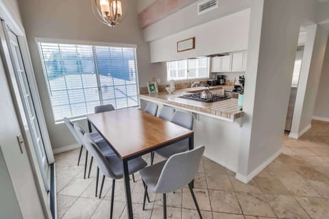 Dining table sitting up against the kitchen bar