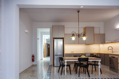 Modern kitchen area in sandy colors and a large table for all the family members
