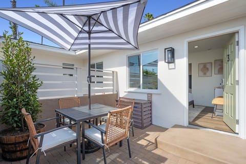 Enjoy your semi-private patio, featuring a table and umbrella, where you can relax and embrace the refreshing ocean breeze.