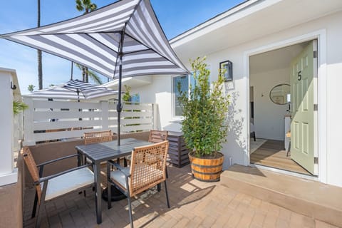 Enjoy your semi-private patio, featuring a table and umbrella, where you can relax and embrace the refreshing ocean breeze.