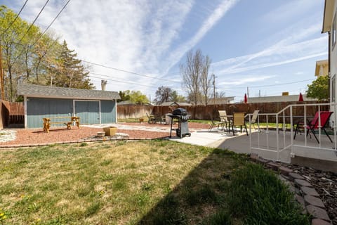 Large back yard with many seating options and grill