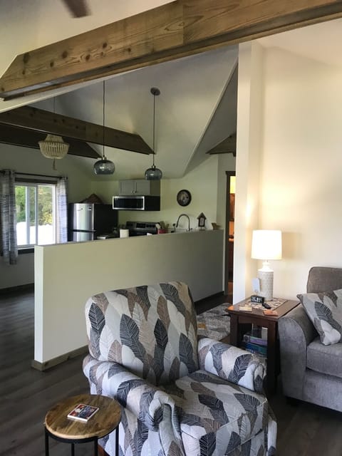 Living room view into the kitchen.  Gorgeous wood beams throughout the the home