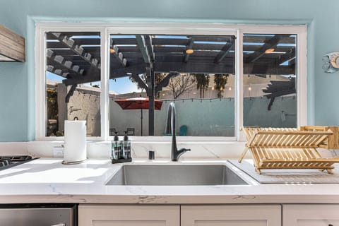 Modern kitchen with big windows. Keep an eye on the pool while prepping food.