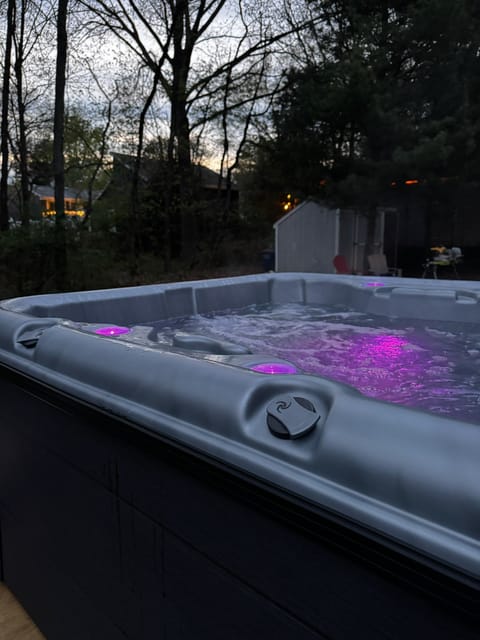 Hot tub in the backyard with changing light display and water fountain feature