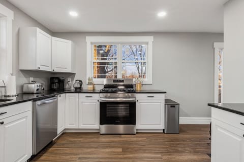 open, L shaped kitchen with lots of natural sunlight