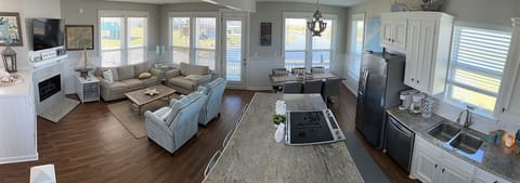 Panoramic view of the living, dining, and kitchen spaces. Huge island seats 4.
