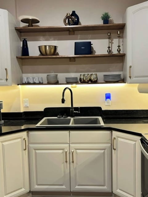 Fully equipped kitchen with stainless steel appliances and granite countertops.