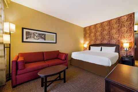 Unwind in a cozy king room with inviting lounge seating.