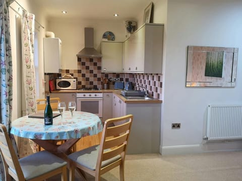 Dining area and kitchen with round table and chairs