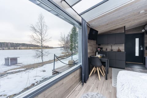 The studio`s open-plan layout is designed to immerse you in the breathtaking scenery. From the modern kitchenette to the cozy dining area, the entire space is oriented toward the stunning, unobstructed views of the tranquil lake and surrounding nature.