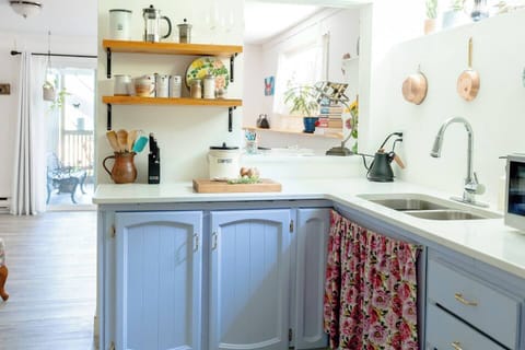 Another angle of the kitchen with view of desk area and living room