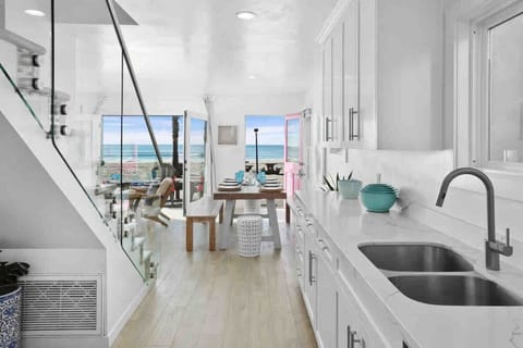 `Fully stocked kitchen with modern appliances, spacious dining table, and everything needed for family meals.`