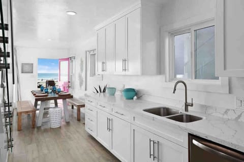 `Fully stocked kitchen with modern appliances, spacious dining table, and everything needed for family meals.`