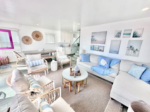 `Bright and open living space with Smart TV, ocean views, and comfortable seating – perfect for relaxing after a day at the beach.`