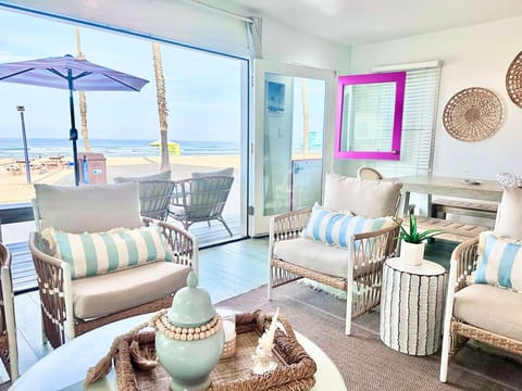 `Bright and open living space with Smart TV, ocean views, and comfortable seating – perfect for relaxing after a day at the beach.`
