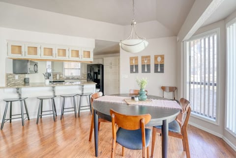 Bright and inviting dining area with modern furnishings, natural light, and a stylish open kitchen.